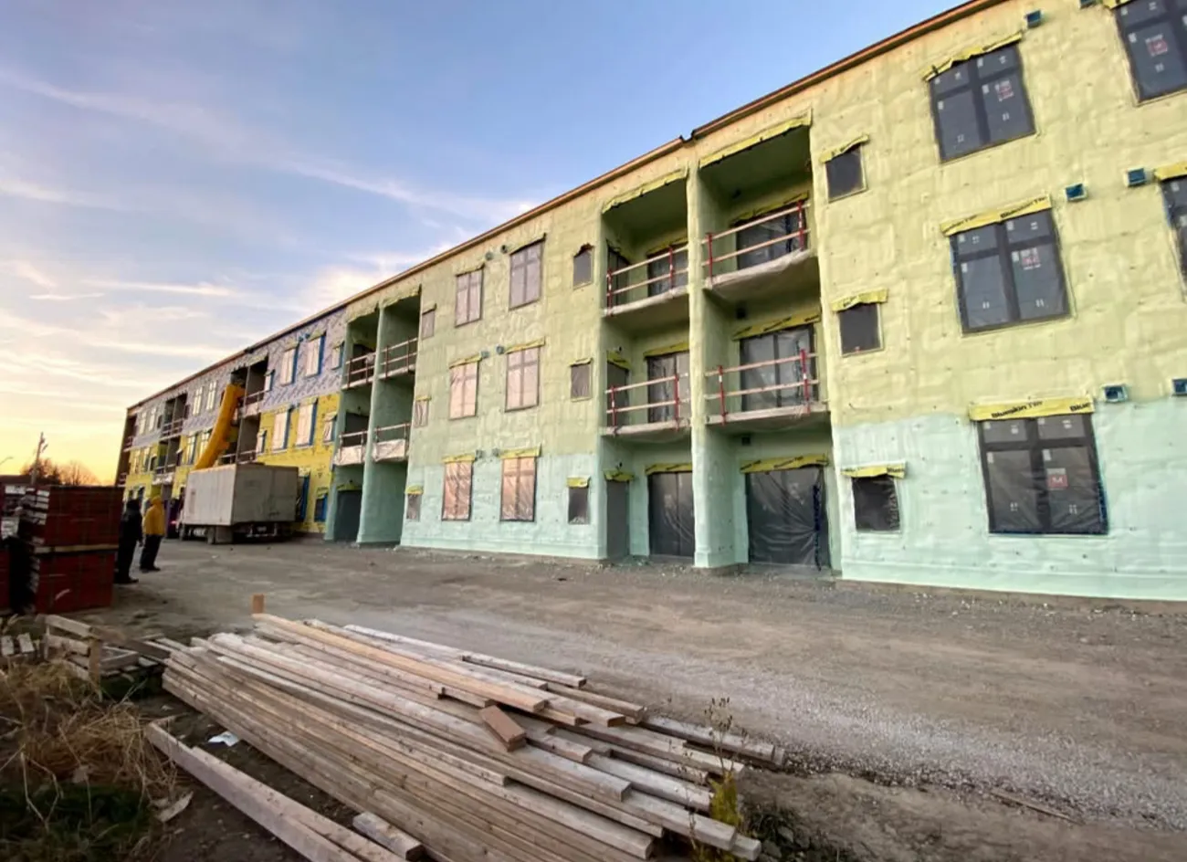 Multi-storey building envelope insulated with closed-cell spray foam